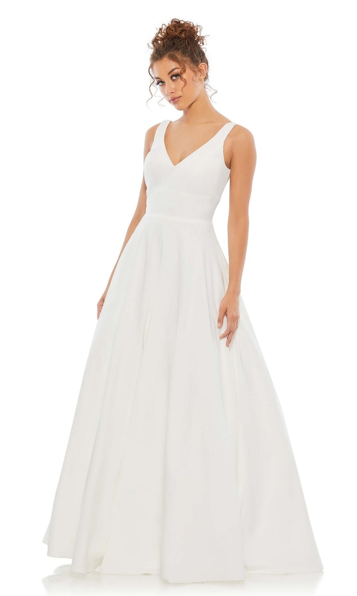 A woman in a sleeveless Mac Duggal 48924 Classic Long Prom Ball Gown with a fitted bodice and flared skirt stands against a plain white background.